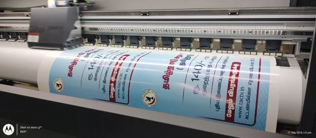 Large-format promotional graphics moving through the print machine
