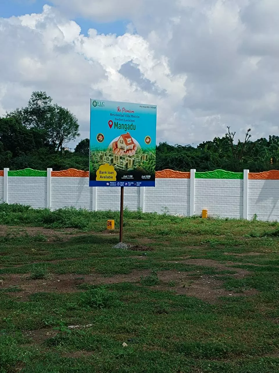 Villa-plot site board installed at a Mangadu development frontage